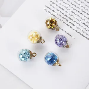 DIY glass ball pendants with colorful heart sequins and bronze loops for jewelry making