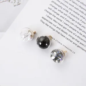 Three glass globe heart pendants with glitter fill and gold loops for DIY jewelry making