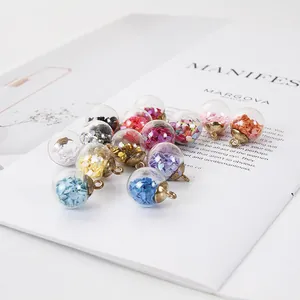 Macro detail of colorful heart sequin filled glass ball charms for DIY jewelry making