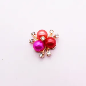 Macro detail of alloy flower charm with three colorful pearls and tiny zircons
