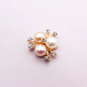 Detailed macro view of a floral alloy pendant featuring three pearls and six crystals