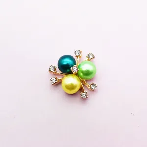 Detailed shot of multi-colored pearl flower brooch with sparkling crystal rhinestones