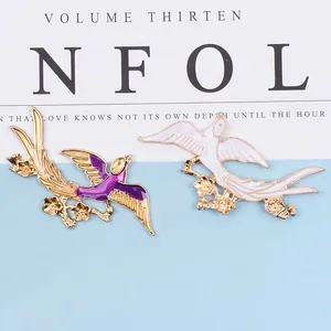 Enamel swallow bird brooches with gold wings and plum blossoms set in vintage style