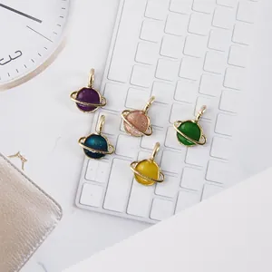 Five colorful Saturn-shaped enamel planet charms with glitter finish for DIY jewelry making