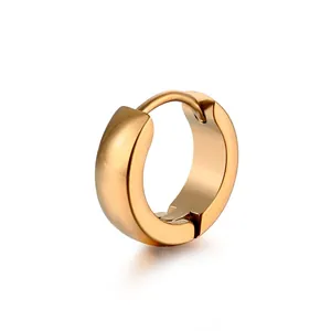 Macro detail of high-polish thick golden titanium steel hoop earring with mirror finish