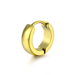 Close-up of polished gold-plated stainless steel huggie earrings with a sleek convex surface