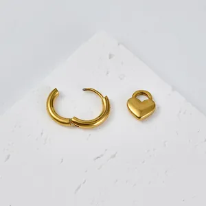 Polished gold stainless steel hoop earring with a minimalist heart-shaped charm pendant