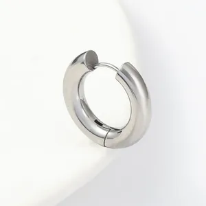 Minimalist silver stainless steel huggie earring with polished mirror finish on white base