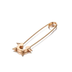 Detailed macro of a rose gold safety pin earring with punk rivets and polished finish