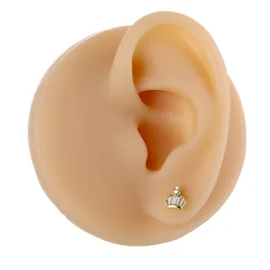 Detailed view of crown shaped gold stud earring featuring micro-pave cubic zirconia crystals