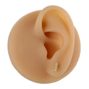 Detailed view of a gold-plated screw stud earring with six micro-inlaid cubic zirconia stones
