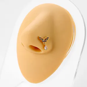 L-shaped gold nose stud with blue gem and waterdrop zirconia pendant on model
