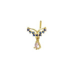 L-shaped gold nose stud with blue wing accents and a dangling clear teardrop gemstone