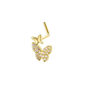 Detail of L-shaped gold nose stud with double butterfly design and pavé cubic zirconia