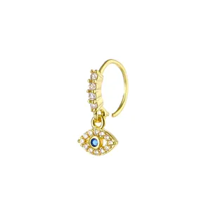 Detailed view of a gold evil eye nose ring with sparkling white and blue zirconia stones