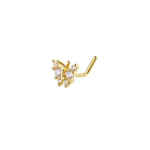 Close-up of golden butterfly L-shaped nose stud with sparkling cubic zirconia inlay