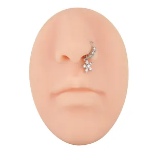 Silver nose ring with sparkling cubic zirconia flower pendant on a silicone model