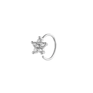 Classic silver-colored five-pointed star nose ring set with sparkling zircons on white backdrop