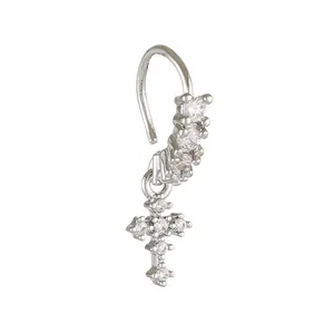 Macro shot of silver nose ring with cubic zirconia inlay and dangling cross pendant detail