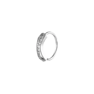 Close-up of a silver-toned nose ring featuring small micro-paved cubic zirconia stones