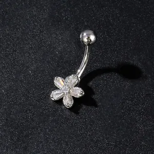 Macro view of silver butterfly belly button ring with zircon floral petals and metal rod