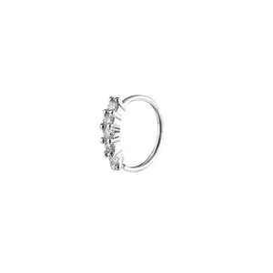 Detailed view of silver nose ring with five white cubic zirconia stones in a claw setting