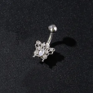 Macro shot of silver butterfly belly ring with sparkling zircons on a black background