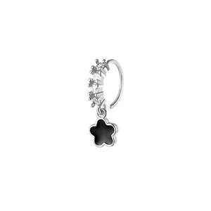 Silver nose ring with sparkling zircons and a black flower petal pendant on white backdrop