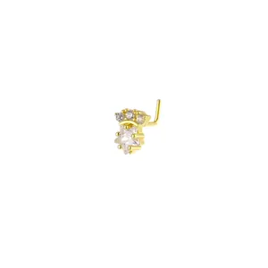Detail shot of golden L-shaped nose stud featuring crown and star-cut cubic zirconia