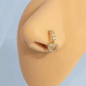 Golden heart pendant nose ring with sparkling cubic zirconia on a realistic model