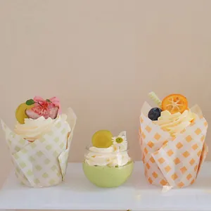 Dettaglio di pirottini a tulipano a scacchi e dessert alla crema con frutta fresca