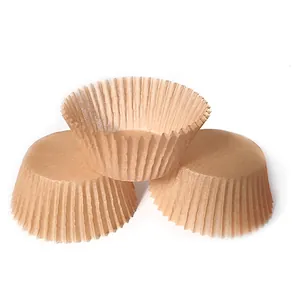 Close-up of three brown kraft paper cupcake liners showing scalloped edges and texture