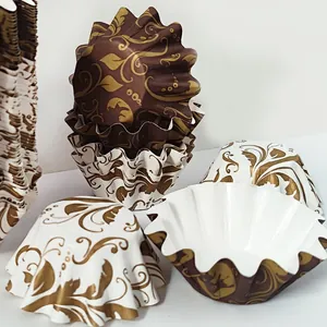 Detail of high-temperature resistant muffin paper liners with golden floral patterns