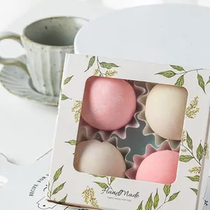 Detail of a white gift box with 4 handmade mochi desserts and floral window packaging