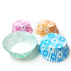 Detail view of colorful floral checkered greaseproof cake paper liners for baking muffins
