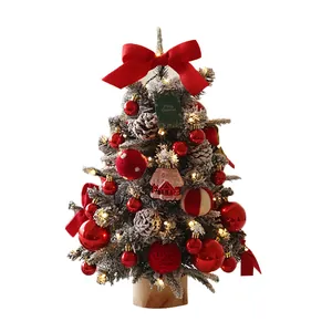 Mini tabletop flocked Christmas tree with red ornaments and warm LED fairy lights
