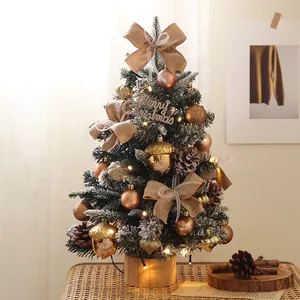 Detailed close-up of a 45cm mini DIY Christmas tree with snow flocked needles and warm lights