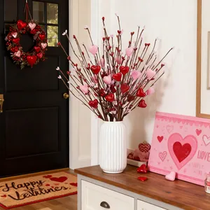 Valentine artificial red heart berry stems in a white ceramic vase for home decor