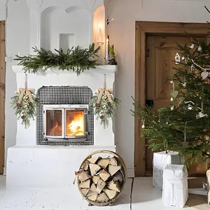 Set of 2 Christmas teardrop swags with pine cones, white berries and burlap bows on fireplace