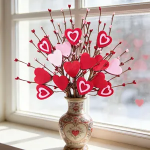 Felt heart decorative branches in vintage ceramic vase for Valentine home decor