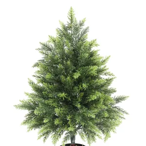 Close-up of realistic green needles and textured branches of the artificial cedar tree