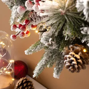 75cm snowy Christmas wreath with red berries, pine cones and warm LED string lights