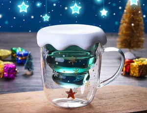 Close-up of double-walled Christmas tree glass cup with white snow lid and snowflake pattern