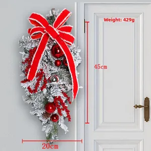 Detail of 45cm Christmas wreath with red bow, pine cones, and snowy flocked texture
