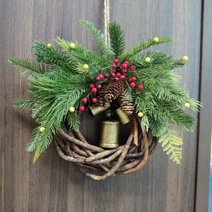 Close-up of rustic Christmas wreath with metal bells, berries, and pine cones on wood