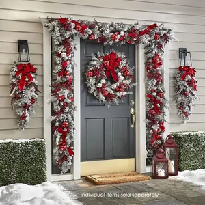 Detail of Christmas flocking wreath and garland with red bows for festive door decor