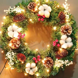Christmas wreath with pine needles, cones, cotton balls and warm LED lights for door decor