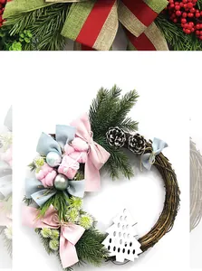 Detail of Christmas rattan wreath with pine cones and pink velvet bows decoration