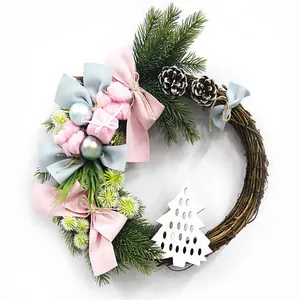 Christmas rattan wreath with pink cotton, pine cones and blue bows for wall decor