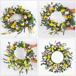 Detail view of artificial eucalyptus wreath with yellow daisies and lavender blooms